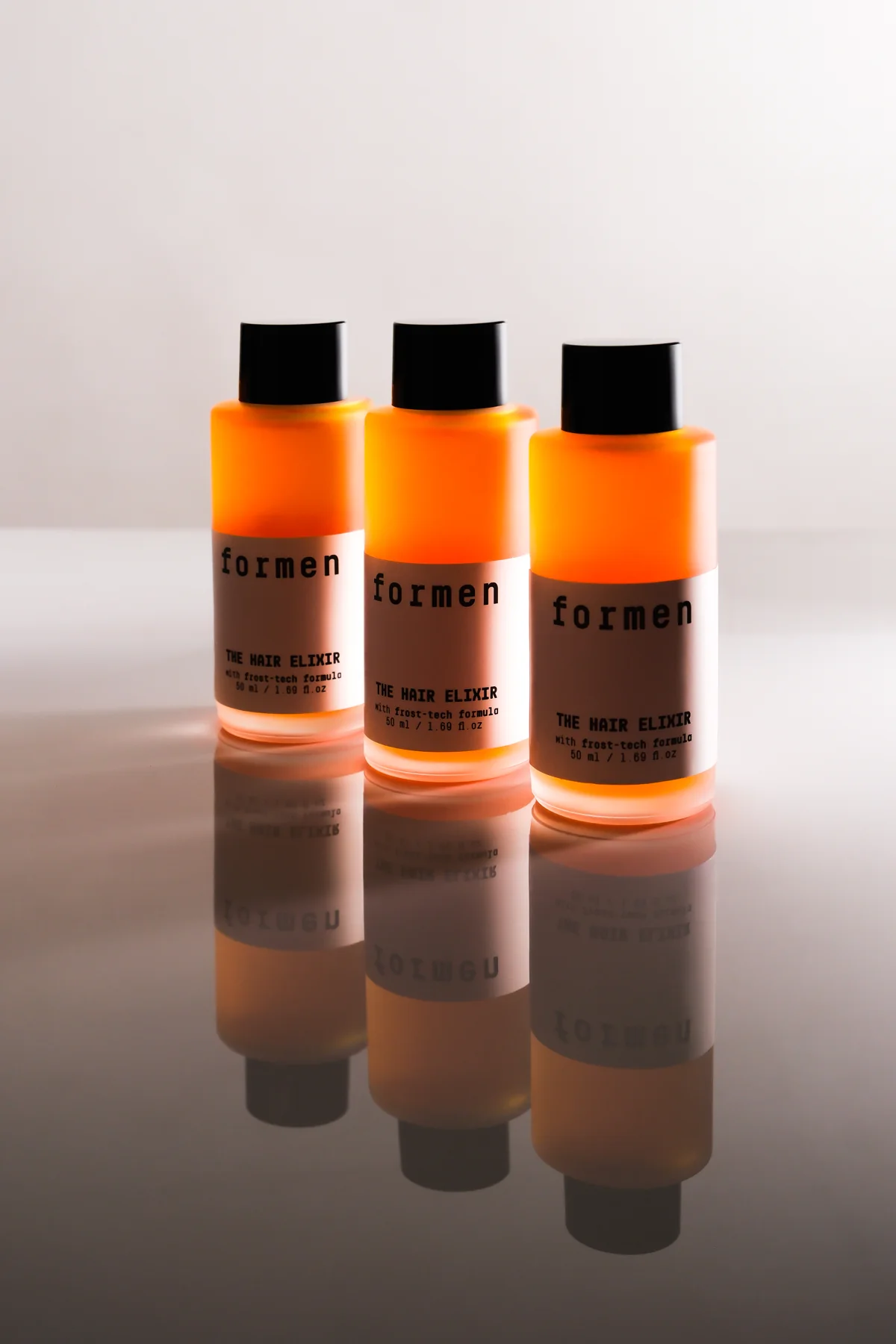 Tiga botol jingga FORMEN The Hair Elixir